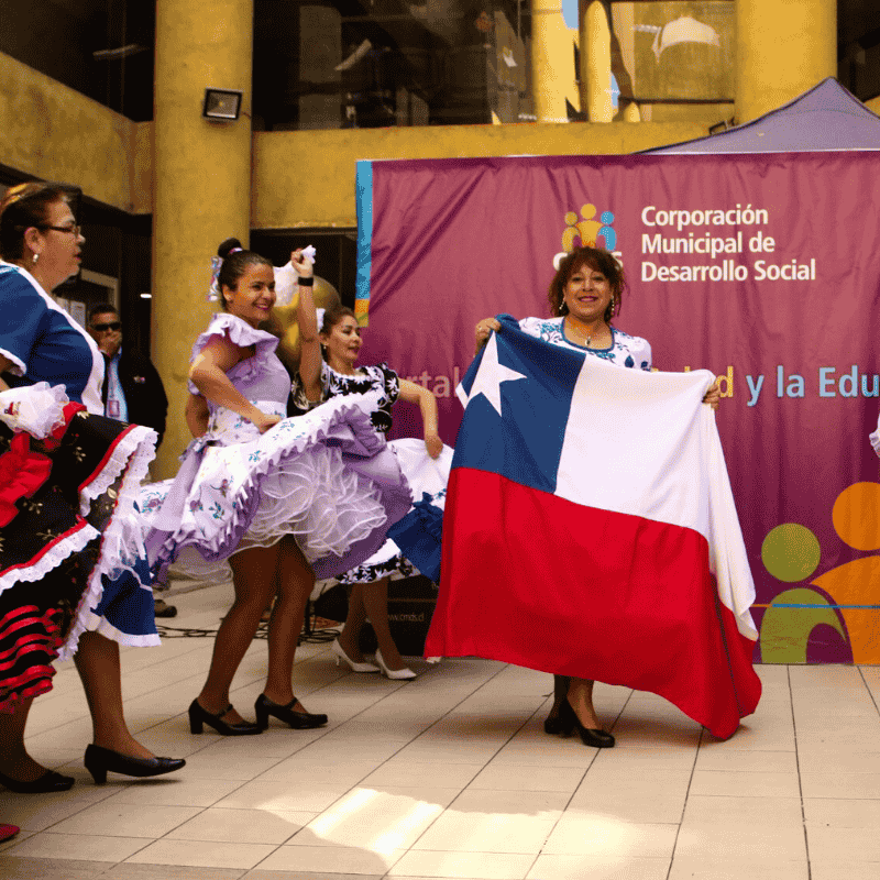 mujeres bailando con vestidos folclóricos creados en la capacitación textil de DVC capacitaciones